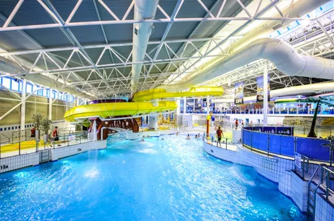 The main pool and yellow flumes inside The Time Capsule Waterpark.