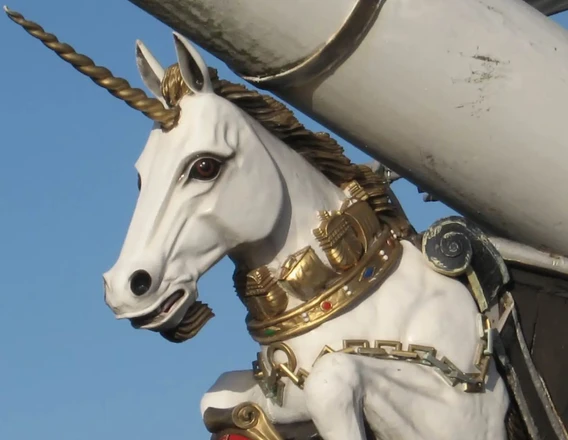 The white unicorn figurehead on HMS Unicorn, with a gold horn and crown.