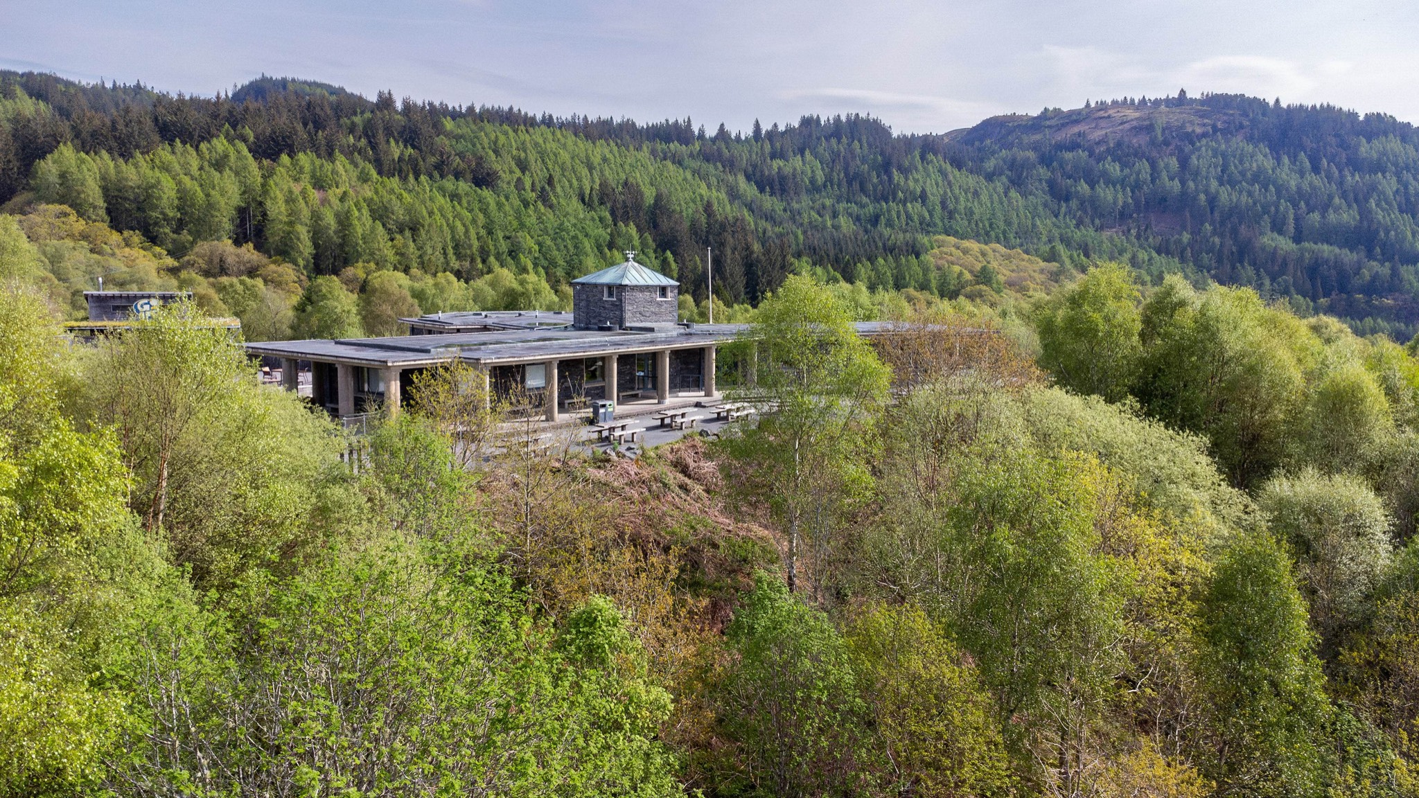 The Lodge Forest Visitor Centre surrounded by woodland above Aberfoyle.